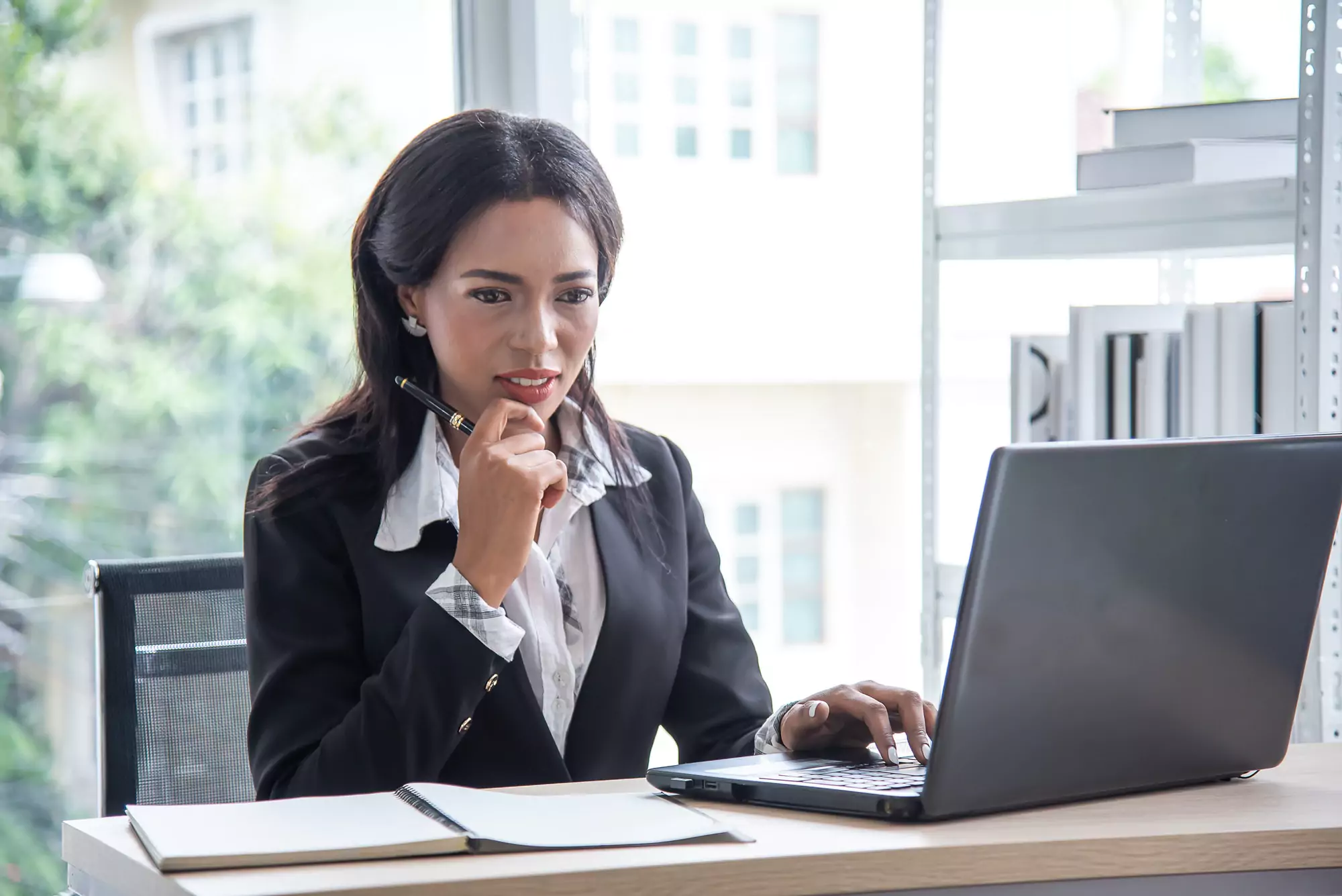 African business woman working in office using computer and think planning marketing