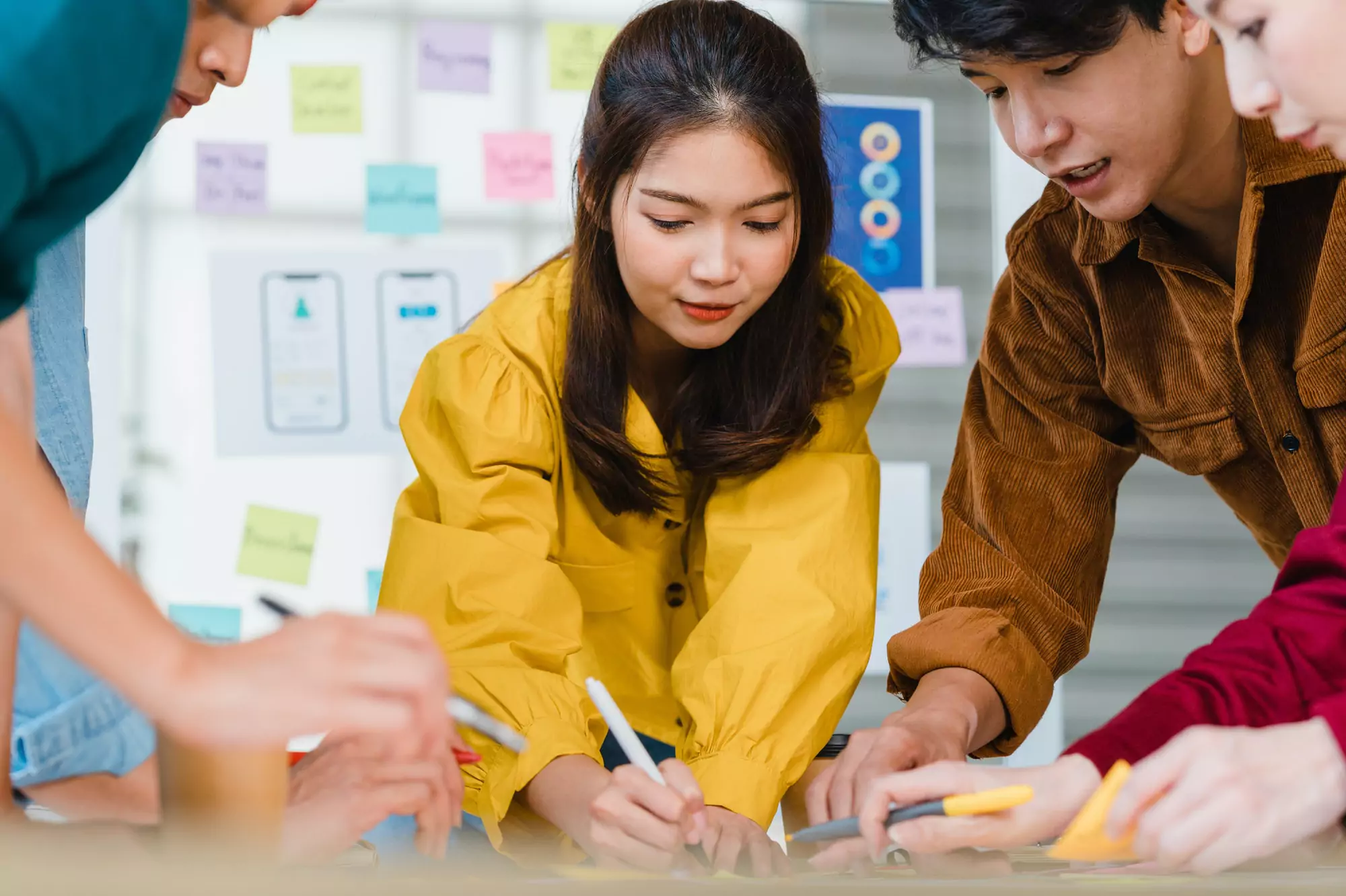 Asian businessmen and businesswomen meeting brainstorming ideas about creative web design planning