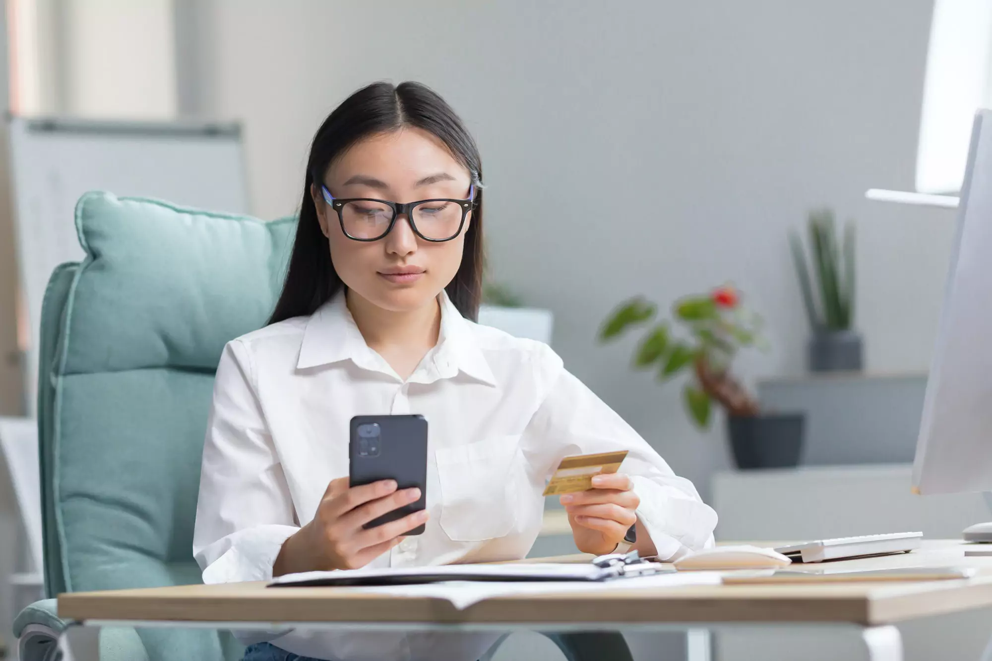Beautiful and confident Asian business woman working in the office, making banking transactions