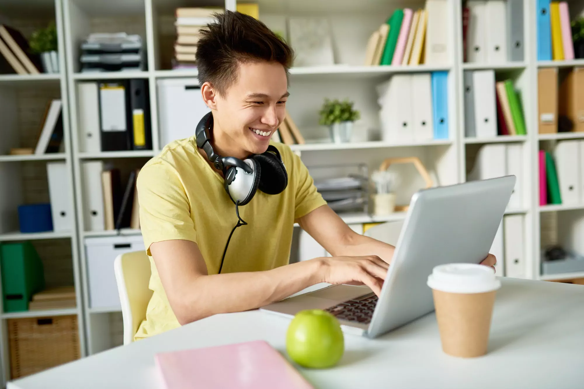 Happy Asian Student Using Laptop