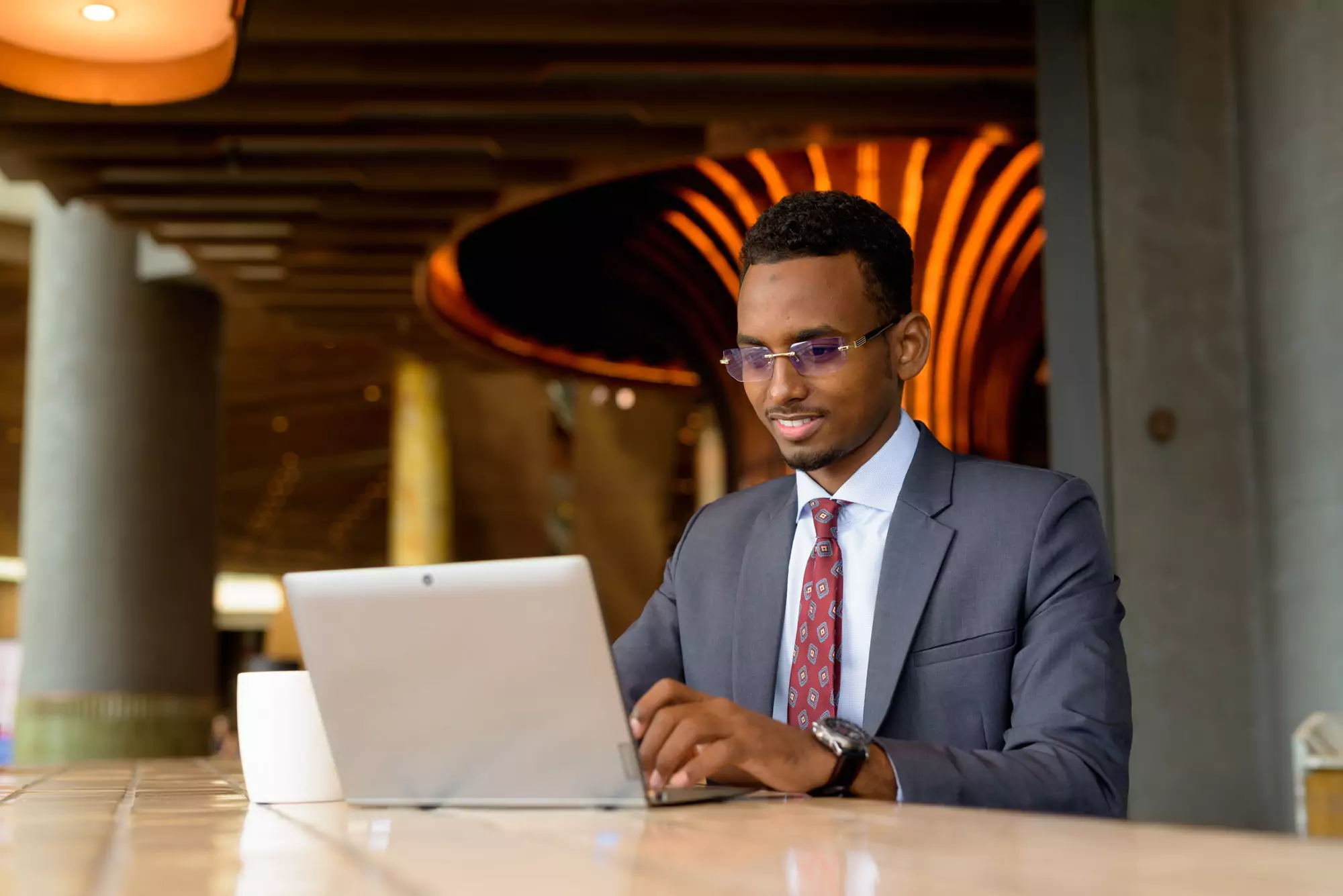 Portrait of African businessman wearing suit and tie in coffee shop