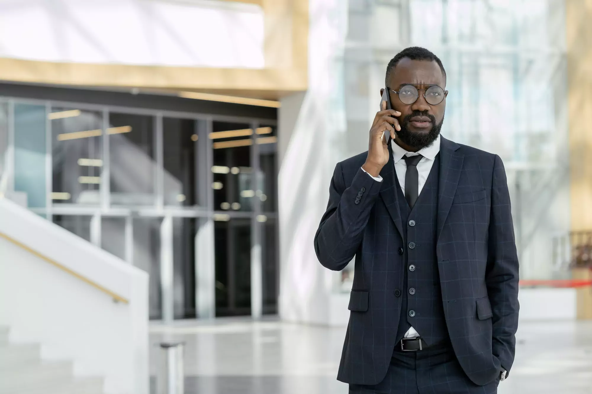 Young African businessman talking to colleague on the phone