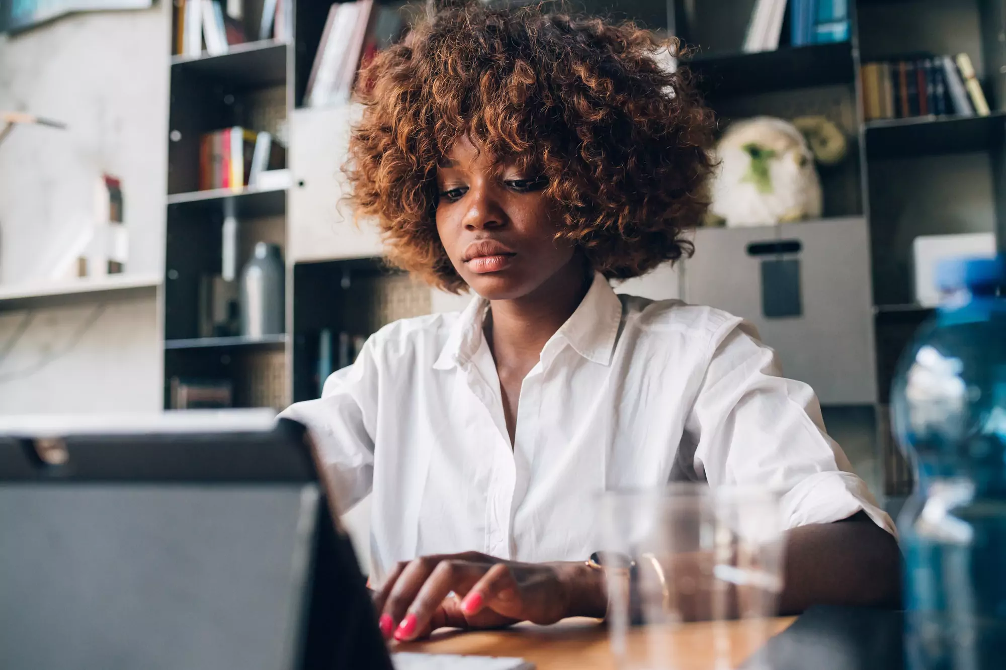 young african student working with tablet on a project in modern studio